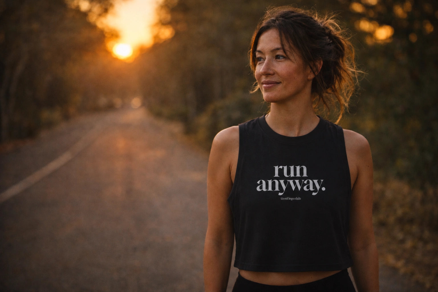 Woman wearing run anyway crop tank at sunset